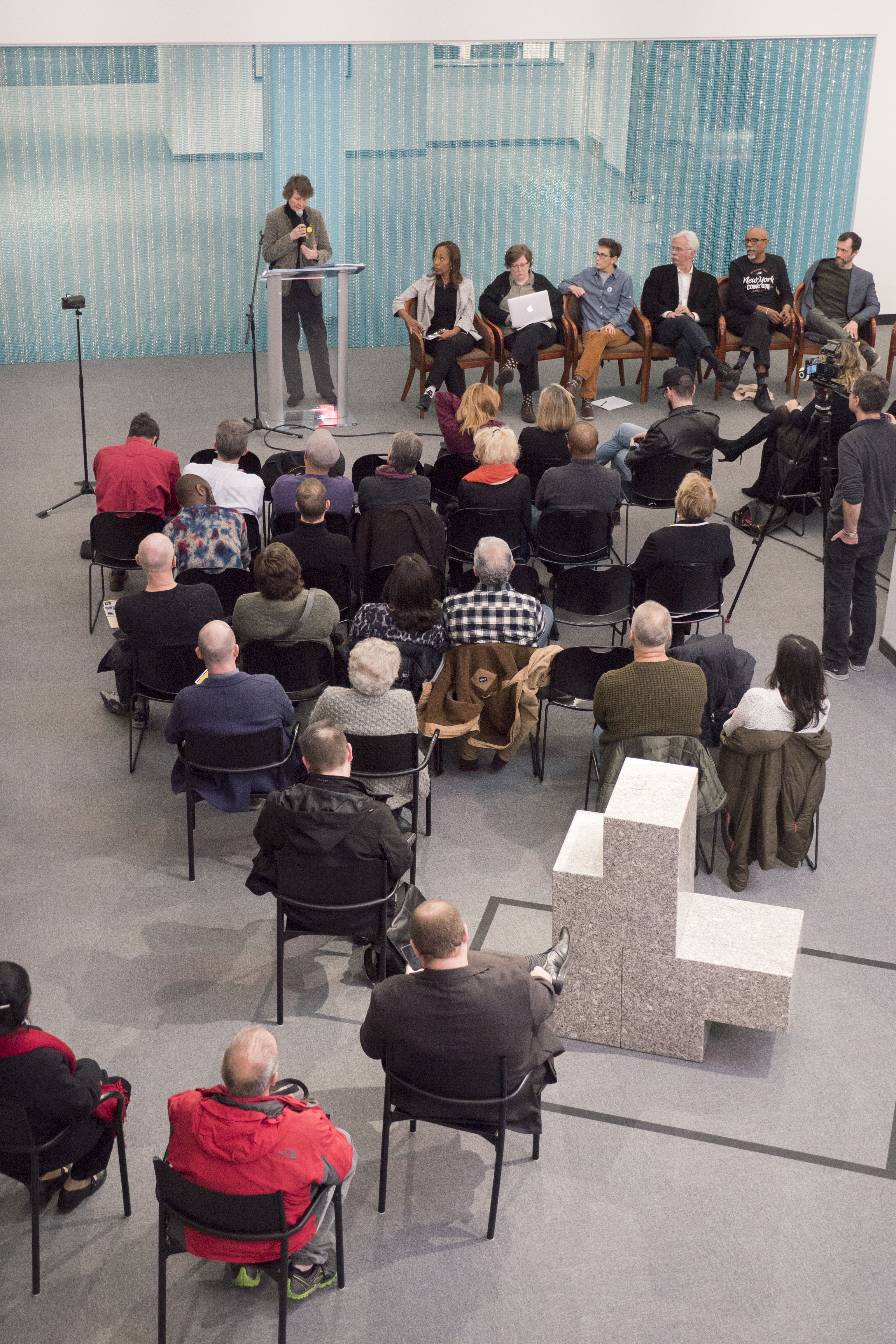 Panel discussion with Stephanie Stebich, director of the Tacoma Art Museum, at the podium, and Scott Burton’s Untitled. Image by JI Yang December 3, 2016